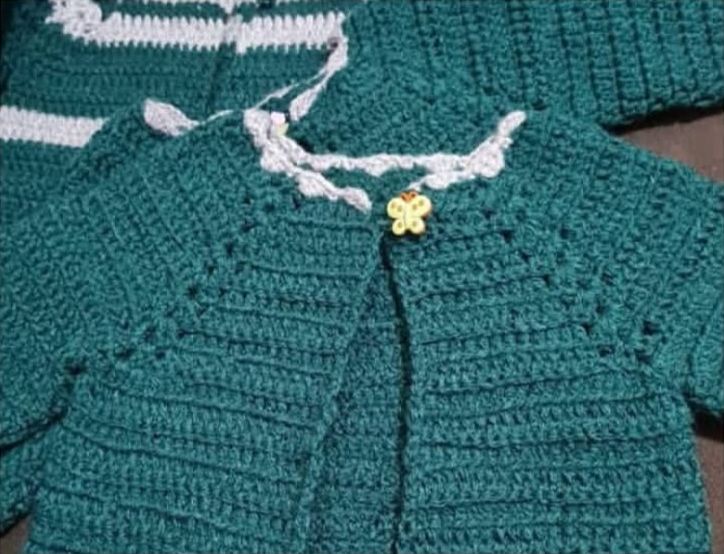 Green crochet baby cardigan with butterfly button