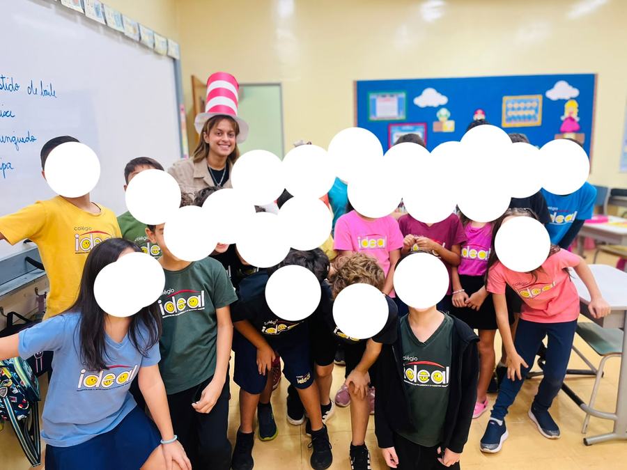 Beatriz in a striped hat with her class